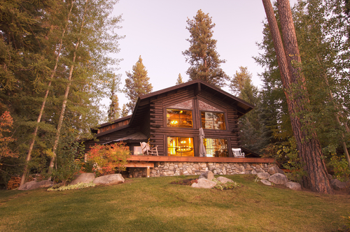 A log cabin surrounded by trees